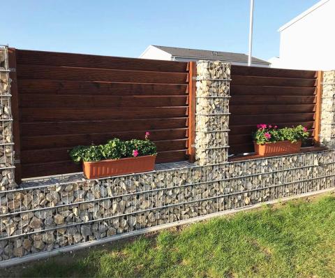 garden gabion fence with wood and flower pots