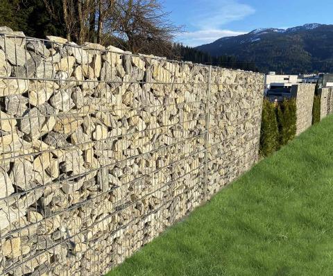 tall gabion fence with hedge