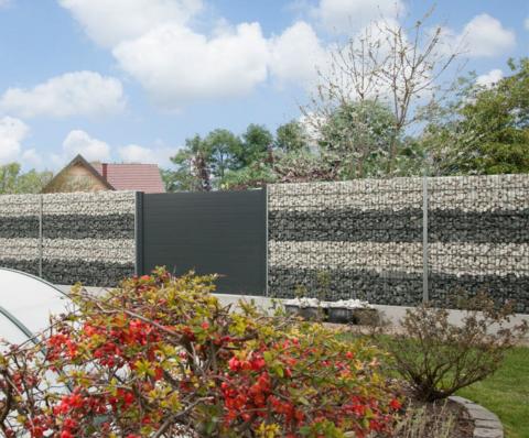 gabion fence with forged gate and stacked stones