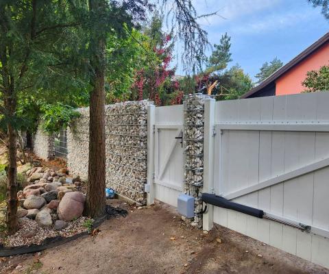 gabion fence Praktik with a white wooden wicket gate and gate